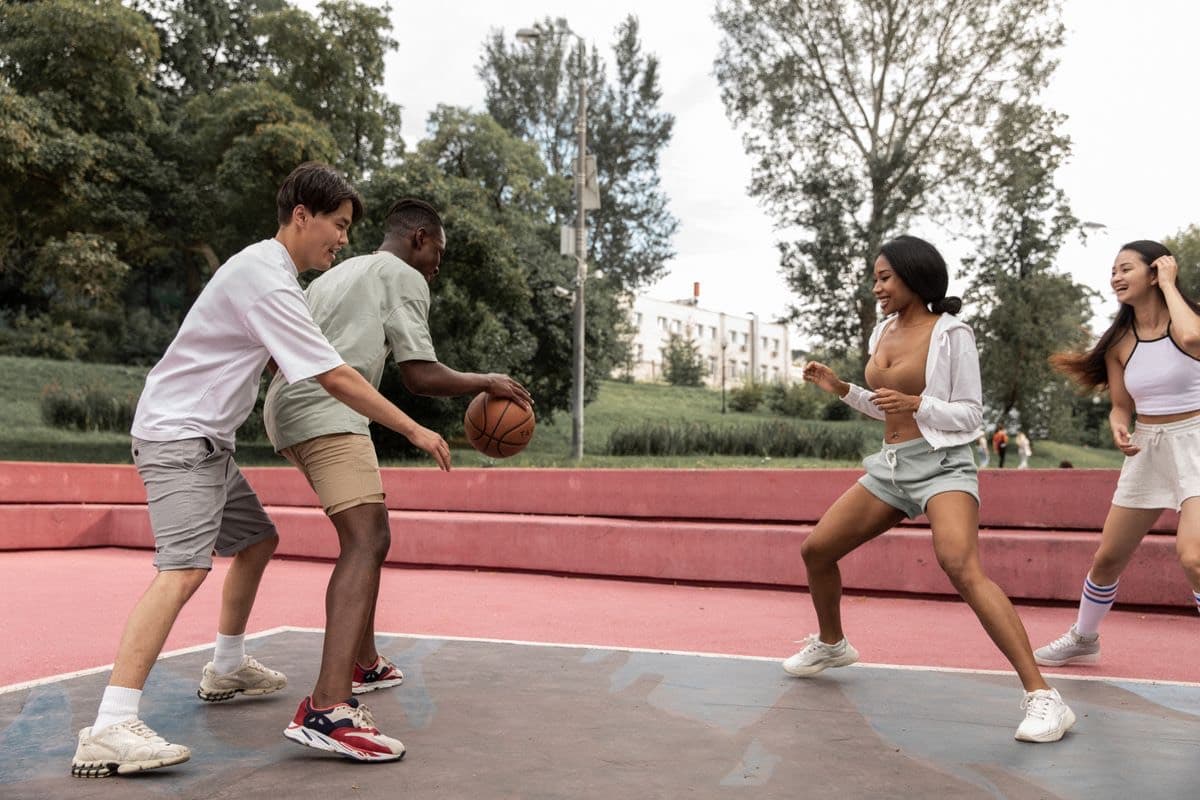 Friends playing pickup basketball on an outdoor court