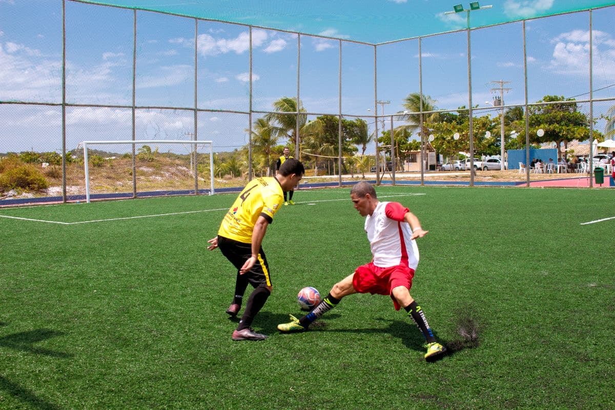 Five-a-side soccer game on a caged turf court
