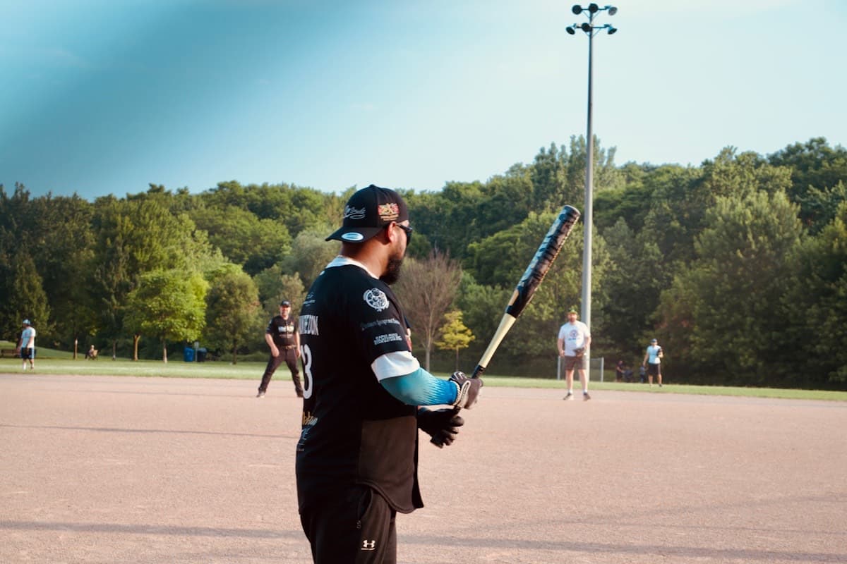 Rec league softball batter waiting at the plate at dusk